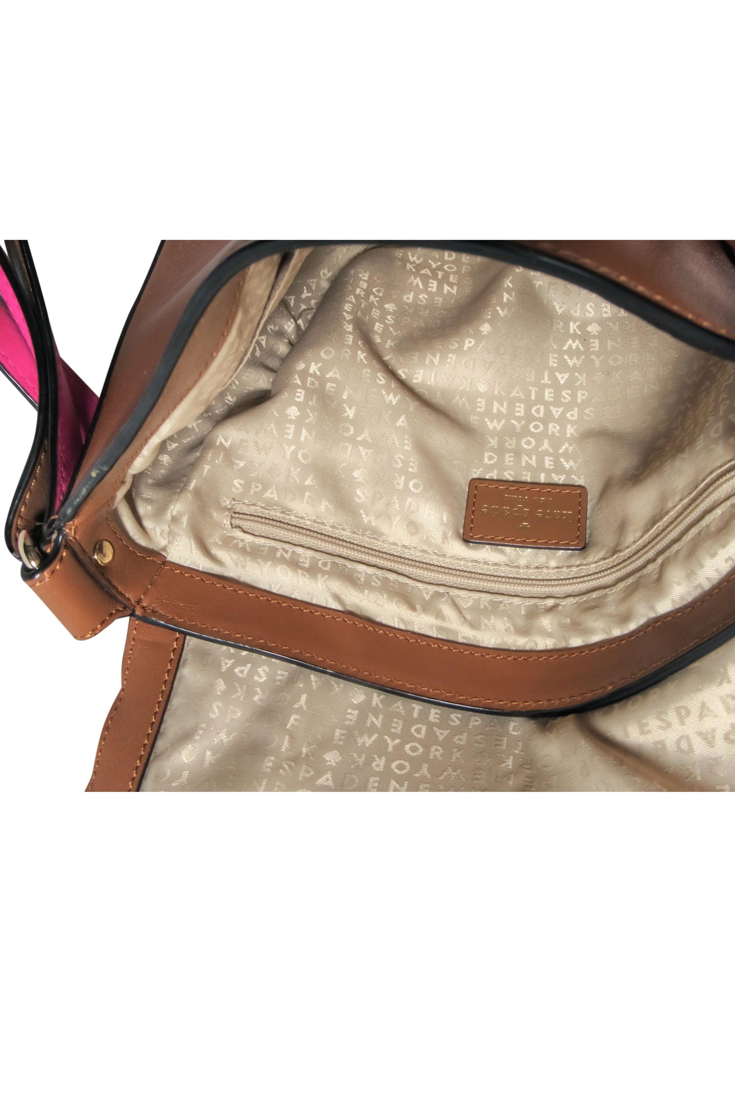 Kate Spade's Stunning Brown Leather Saddle Crossbody Bag with a Pop of Pink Strap
